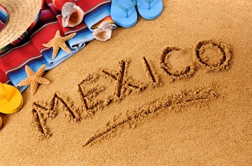 sandy beach with word Mexico etched in middle